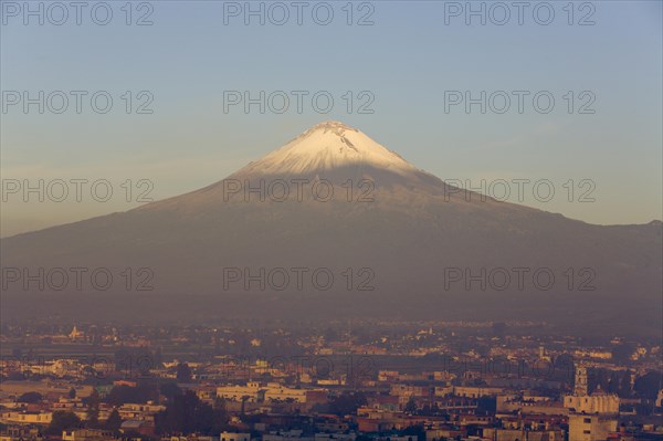 Popocatepetl volcano with the city of Cholula in early morning light