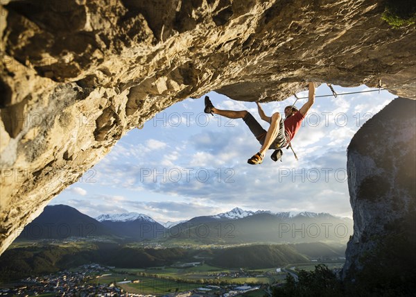 Freeclimber with helmet climbing on a rock face