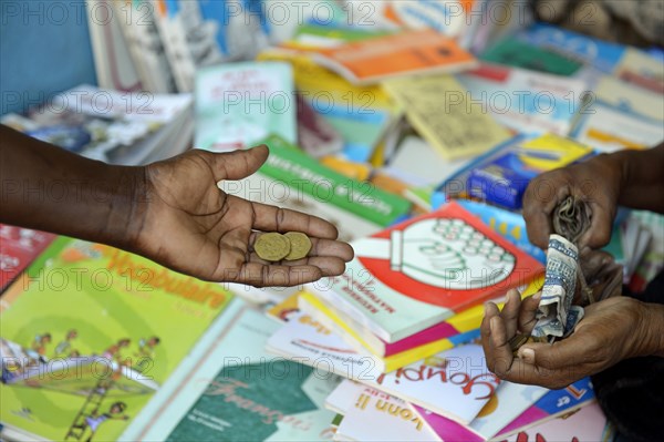 Mother buys school books on the market