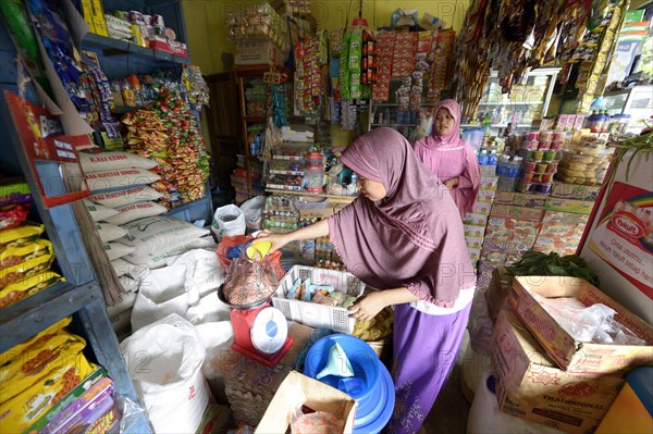 Young woman working in a small grocery store