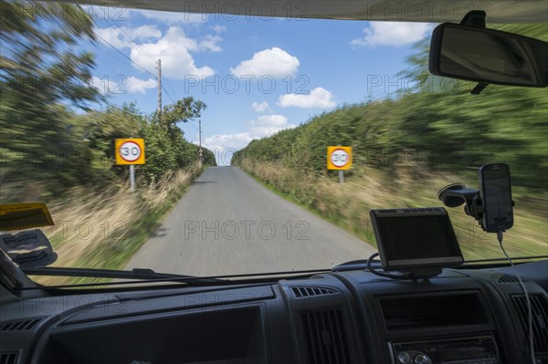 Looking through the front window of a moving camper on the road