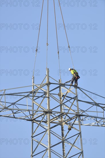 Overhead lineman working on a pylon