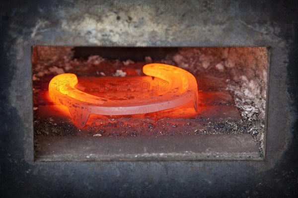 Red-hot horseshoe in the furnace of a blacksmith