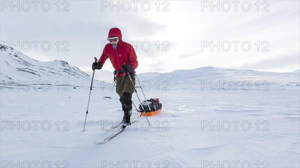 Ski tourers with Pulka in the snow