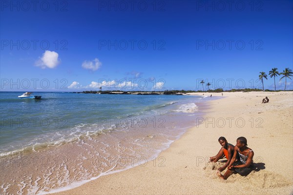 Boys playing on a sandy beach