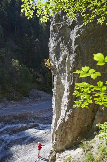Sport climber climbing a rock face