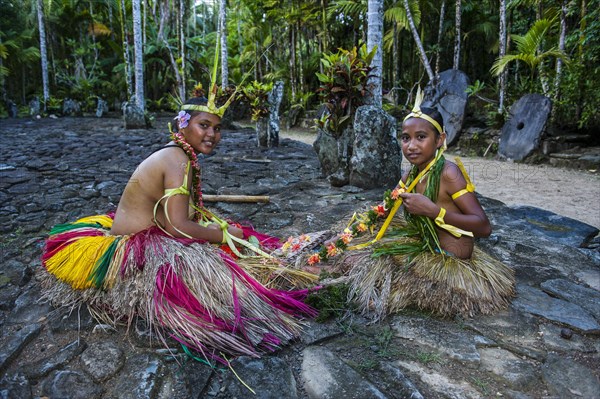 Traditionally dressed islanders making traditional art work