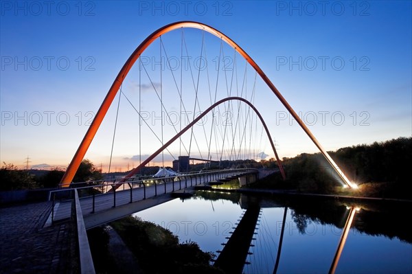 Illuminated double arch bridge over the Rhine-Herne Canal