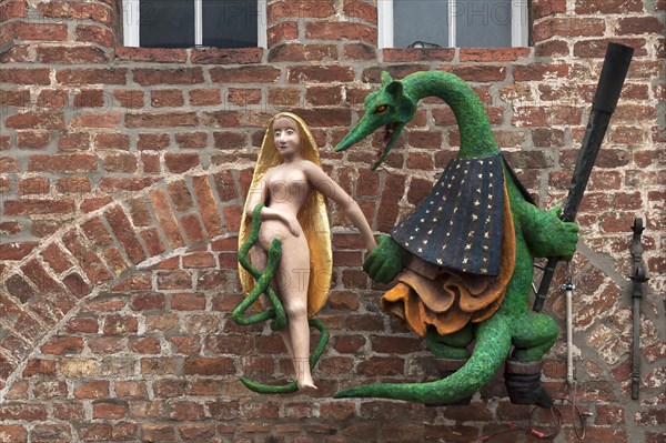 Figures of a dragon and a woman on the facade of the former Hieronymus Restaurant & Cafe