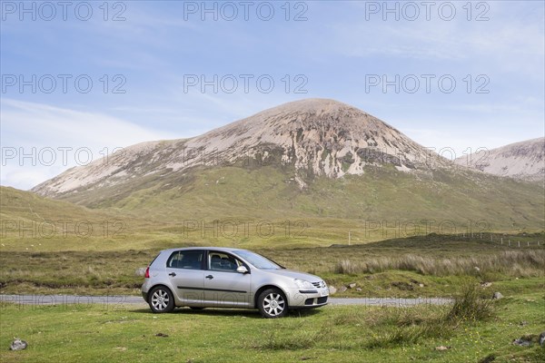 Volkswagen Golf car parked next to road with Beinn Dearg at the back