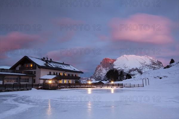 Sunset over Plattkofel and Mahlknechthutte hut in winter