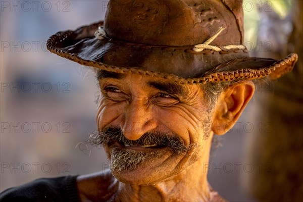 Sugar cane farmer wearing a hat