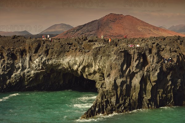 Tourists on the rocky coast of Los Hervideros