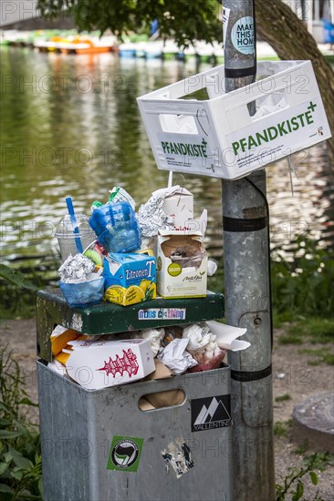 Overflowing public rubbish bin