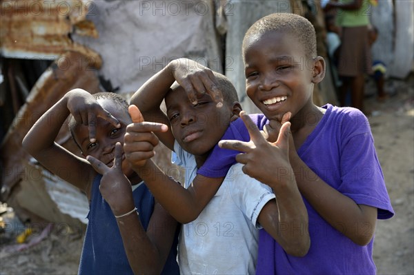 Three boys posing with wild gestures