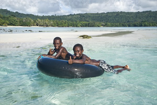 Two boys playing in the clear water