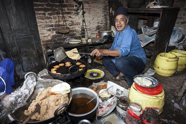 Nepalese man producing fried food