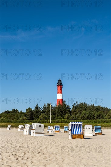 Beach chairs on the beach in front of the lighthouse