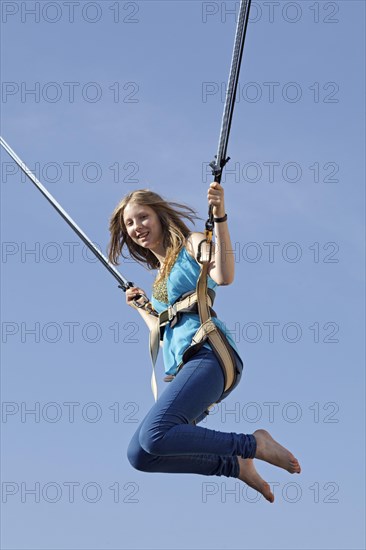 Girl on bungee trampoline