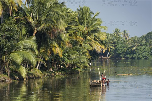 Men collecting sand from a canal with baskets