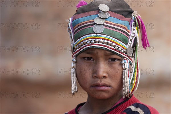 Girl of the Akha ethnic group with traditional headdress