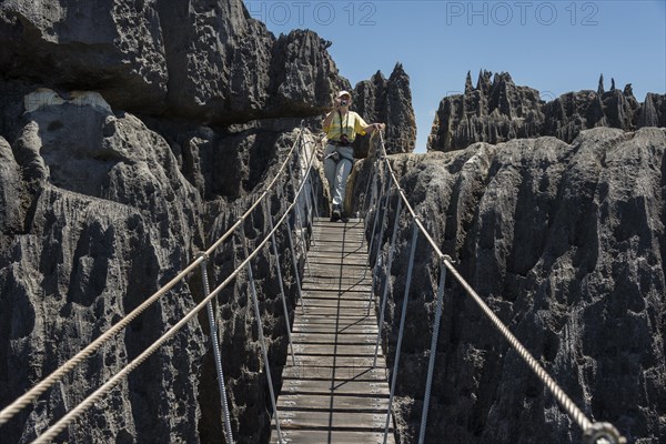 Woman on suspension bridge in the National Park Tsingy du Bemaraha