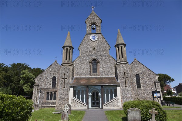 Flint stone built St James Church with bell gable and covered porch