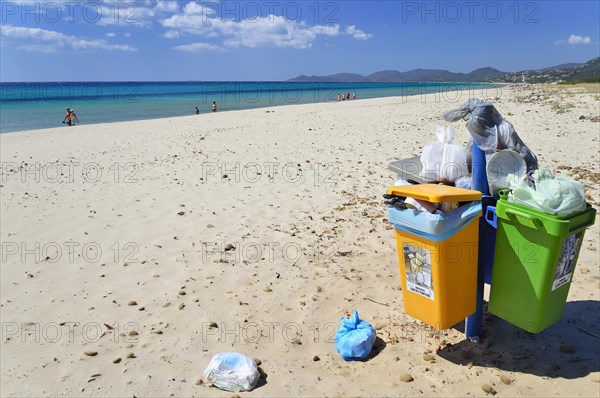 Overflowing trash cans on the beach