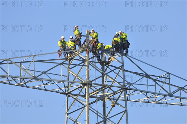 Overhead linemen working on a pylon