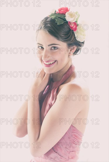 Beauty portrait of a smiling young woman with flowers in her hair