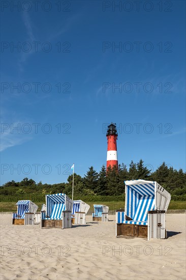 Beach chairs on the beach in front of the lighthouse