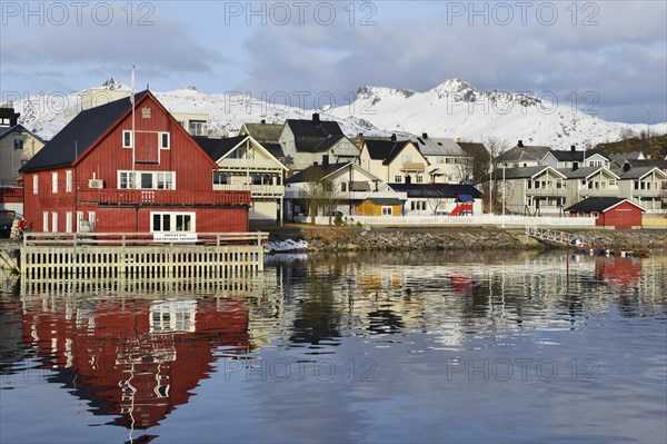 Red house with a private waterfront and several houses in the village