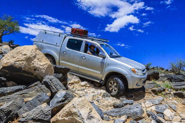 SUV driving down rock steps