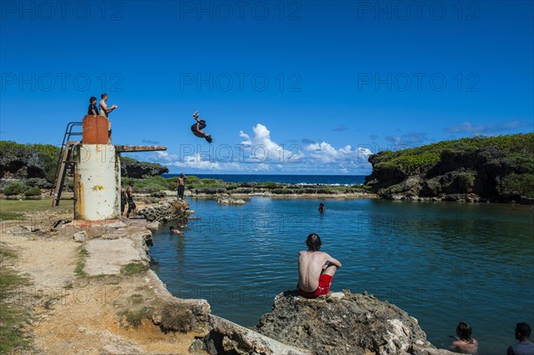 Local boys jumping and swimming in the Salugula Pool