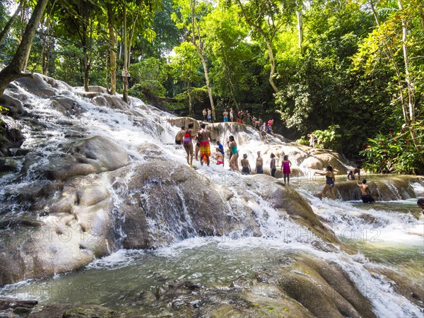 Tourists bathing and climbing the Dunn's River Falls