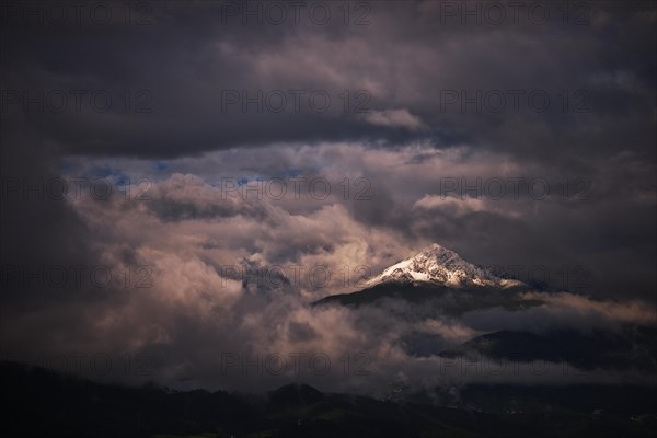 Snow-capped Mt Rosskogel with looming clouds