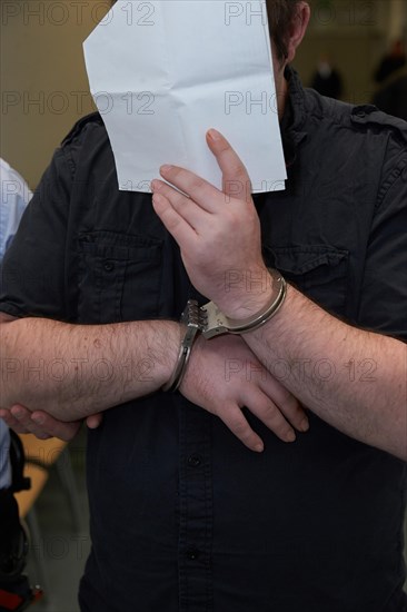 Defendant in handcuffs