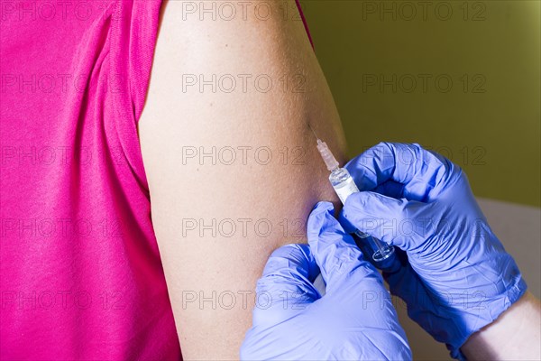 Injection of medicine into an arm