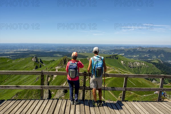 Hiker looking at the mountains of Massif of Sancy