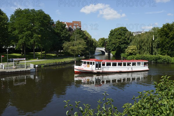 Steamer on the course of the Alster river at the towpath