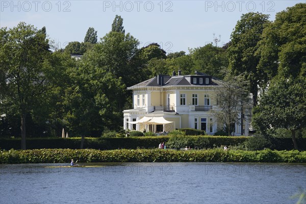 Mansion with a rowing boat at front on the Aussenalster or Outer Alster Lake