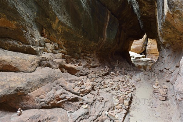 Rock cairns in the narrow canyon of Joint Trail