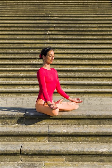 Young woman practising Hatha-Yoga outdoors