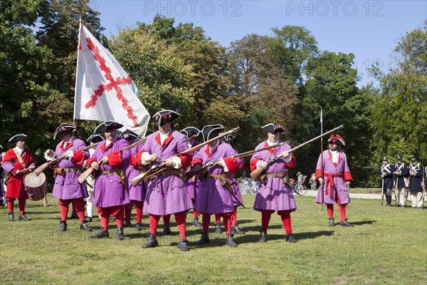 Soldiers with muzzle-loading rifles shooting during live role-playing or ReenLarpment