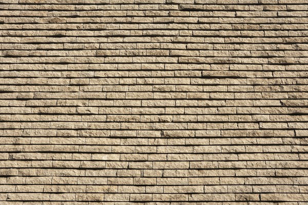 Facade structure made of rough-hewn limestone