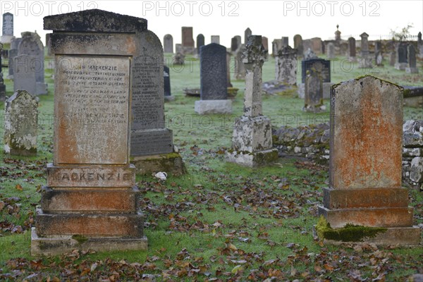 Old Scottish graveyard with Celtic crosses and gravestones with hoarfrost-covered grass