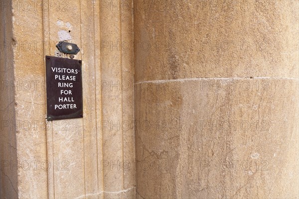 Visitors please ring for hall porter' sign by door bell button