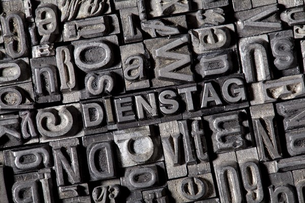 Old lead letters forming the word DIENSTAG