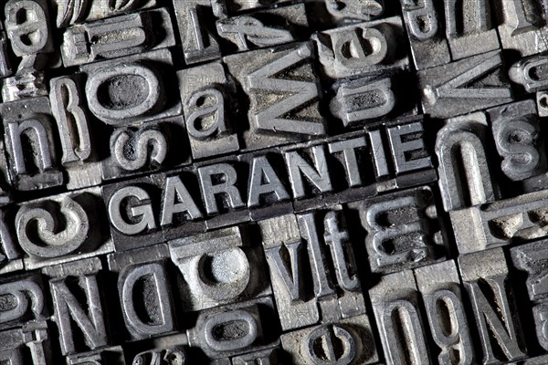 Old lead letters forming the word GARANTIE