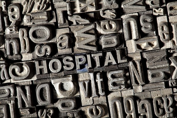 Old lead letters forming the word HOSPITAL